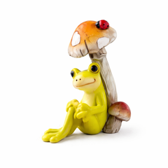 Charming frog under mushroom cap