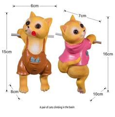 A PAIR OF CATS CLIMBING