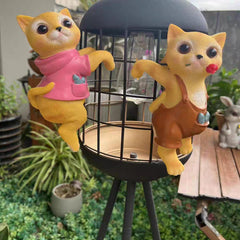 A PAIR OF CATS CLIMBING